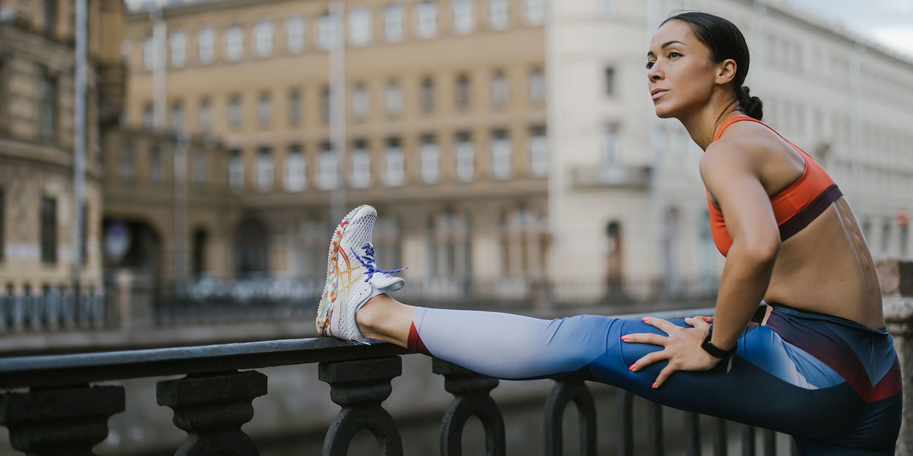 a woman runner stretching her legs