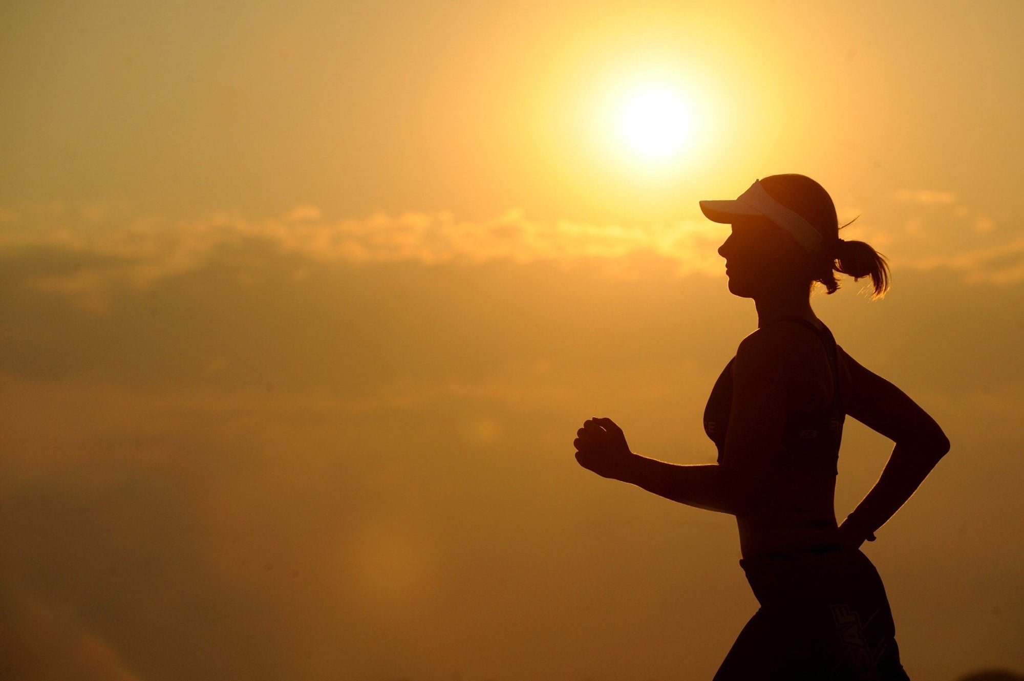 a female runner at sunset